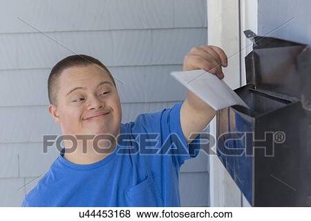 Stock Photo - Teen with Down Syndrome getting mail. Fotosearch