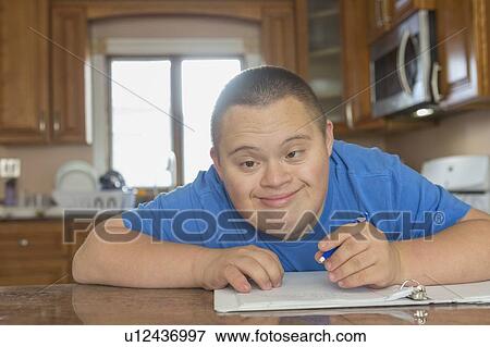 Teen with Down Syndrome studying View Large Photo Image Stock Photo - Teen with Down Syndrome studying. Fotosearch