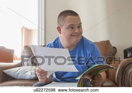 Stock Photo - Teen with Down Syndrome studying. Fotosearch
