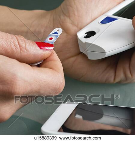 Stock Photo - Testing blood glucose levels. Fotosearch