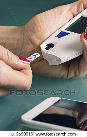 Testing blood glucose levels View Large Photo Image Stock Photograph - Testing blood glucose levels. Fotosearch