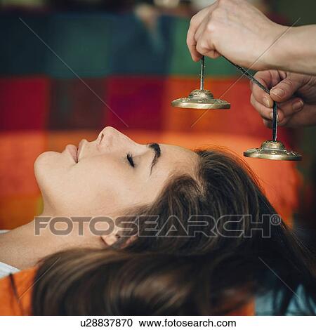 Stock Image - Tibetan bells sound therapy. Fotosearch
