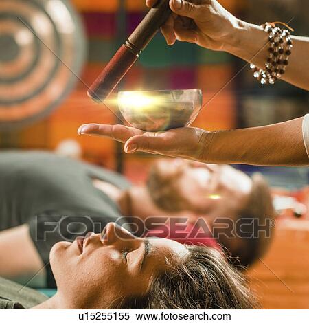 Stock Photography - Tibetan singing bowl therapy. Fotosearch