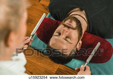 Picture - Tuning fork sound therapy. Fotosearch