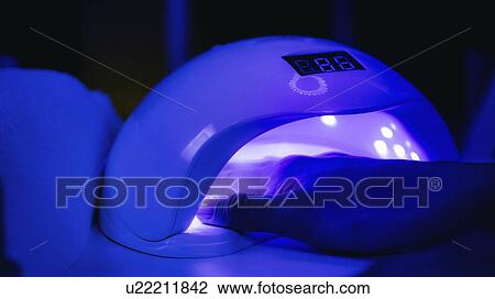 Stock Image - UV lamp for setting nails. Fotosearch