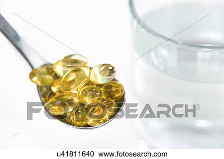 Vitamin E capsules and glass of water View Large Photo Image Stock Image - Vitamin E capsules and glass of water. Fotosearch