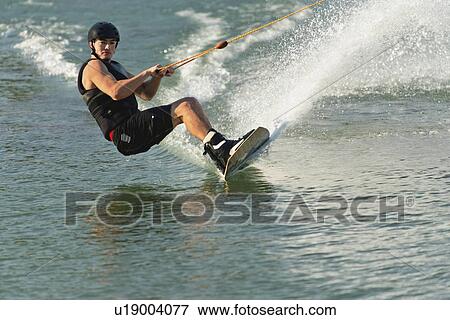 Stock Photo - Wakeboarder cutting water surface. Fotosearch