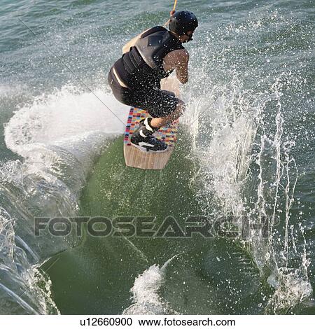 Stock Image - Wakeboarder performing stunt. Fotosearch