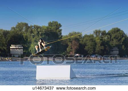 Stock Photo - Wakeboarding performing stunt. Fotosearch