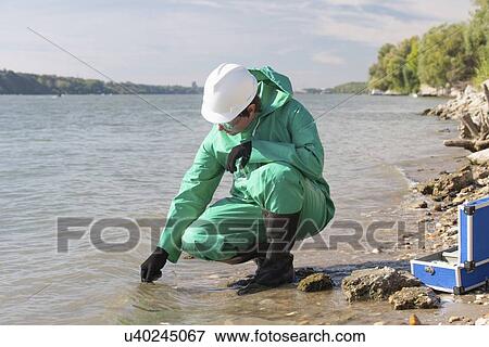 Stock Photo - Water quality inspector filling up sample container. Fotosearch