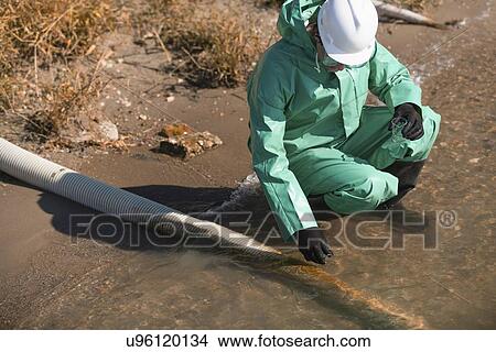 Picture - Water quality inspector taking sample. Fotosearch