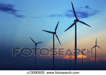 Stock Image - Wind farm against blue sky.. Fotosearch