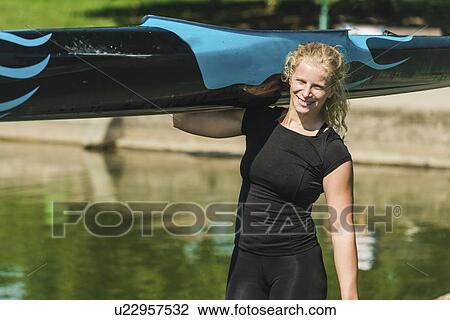 Woman carrying her kayak View Large Photo Image Stock Image - Woman carrying her kayak. Fotosearch