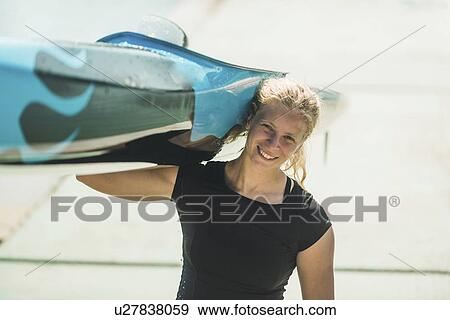 Woman carrying her kayak View Large Photo Image Stock Photo - Woman carrying her kayak. Fotosearch