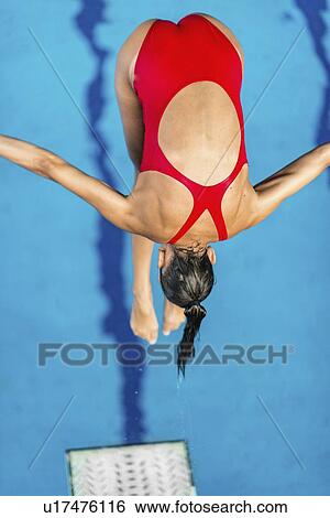Stock Photograph - Woman diving into pool from springboard. Fotosearch