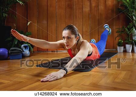 Picture - Woman doing back extension exercises. Fotosearch