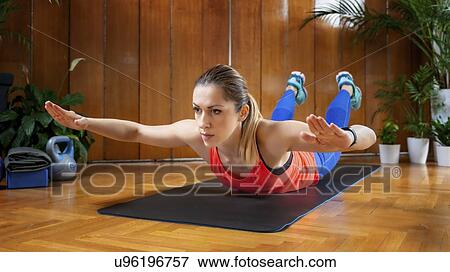 Woman doing back extension exercises View Large Photo Image Stock Photo - Woman doing back extension exercises. Fotosearch