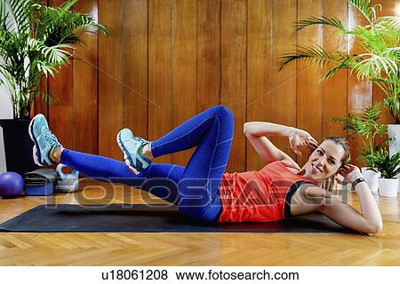 Woman doing Crunches View Large Photo Image Stock Photo - Woman doing Crunches. Fotosearch