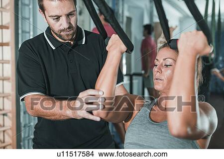 Woman doing TRX workout View Large Photo Image Picture - Woman doing TRX workout. Fotosearch