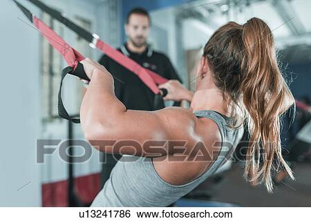 Woman doing TRX workout View Large Photo Image Stock Photograph - Woman doing TRX workout. Fotosearch