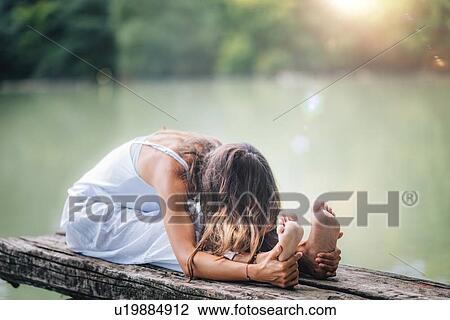 Woman doing yoga by a lake View Large Photo Image Stock Image - Woman doing yoga by a lake. Fotosearch