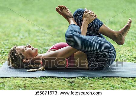Stock Image - Woman doing yoga. Fotosearch