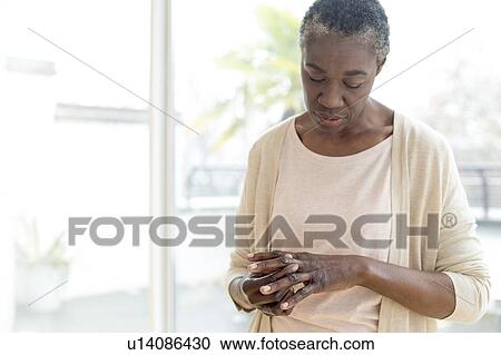 Woman examining her hands View Large Photo Image Stock Image - Woman examining her hands. Fotosearch