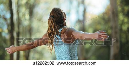 Woman exercising outdoors View Large Photo Image Stock Image - Woman exercising outdoors. Fotosearch