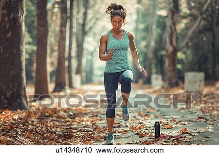 Woman exercising outdoors View Large Photo Image Stock Image - Woman exercising outdoors. Fotosearch