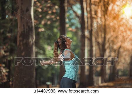 Stock Image - Woman exercising outdoors. Fotosearch