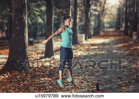 Stock Photo - Woman exercising outdoors. Fotosearch