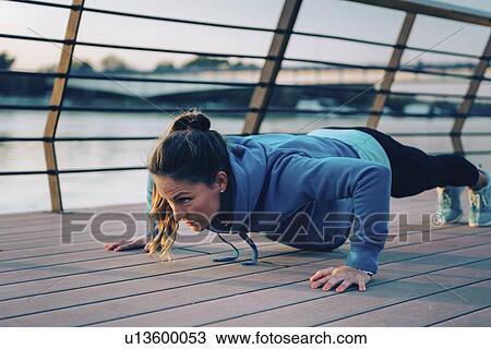Stock Image - Woman exercising outside. Fotosearch
