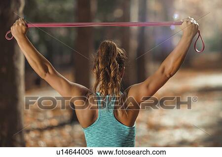 Woman exercising with elastic band outdoors View Large Photo Image Stock Photography - Woman exercising with elastic band outdoors. Fotosearch