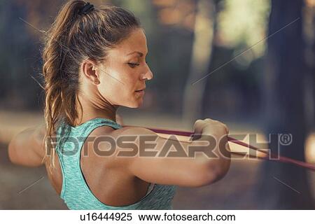 Woman exercising with elastic band outdoors View Large Photo Image Stock Photography - Woman exercising with elastic band outdoors. Fotosearch