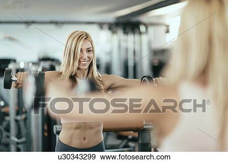 Woman exercising with weights View Large Photo Image Stock Photo - Woman exercising with weights. Fotosearch