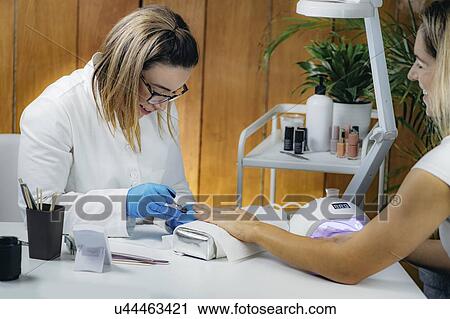 Woman getting manicure View Large Photo Image Stock Image - Woman getting manicure. Fotosearch