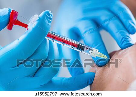 Stock Photo - Woman having hyaluronic acid injections. Fotosearch