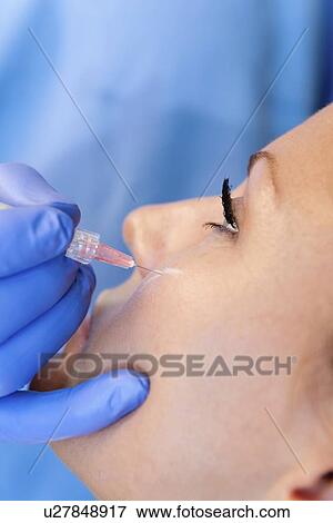 Stock Photo - Woman having hyaluronic acid injections. Fotosearch