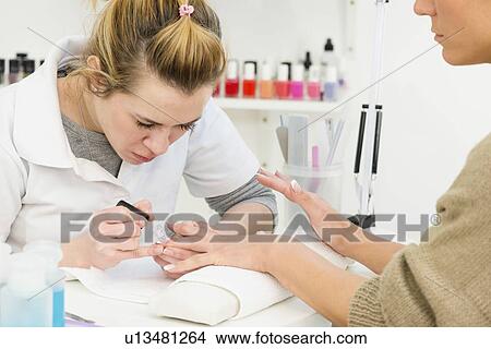Picture - Woman having manicure. Fotosearch