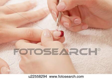 Picture - Woman having manicure. Fotosearch