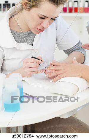 Picture - Woman having manicure. Fotosearch