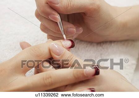 Stock Image - Woman having manicure. Fotosearch