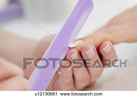 Woman having manicure View Large Photo Image Stock Image - Woman having manicure. Fotosearch