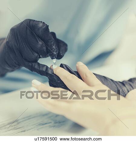 Stock Image - Woman having manicure. Fotosearch