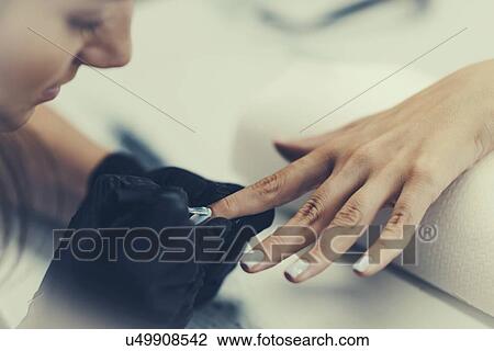 Woman having manicure View Large Photo Image Stock Image - Woman having manicure. Fotosearch