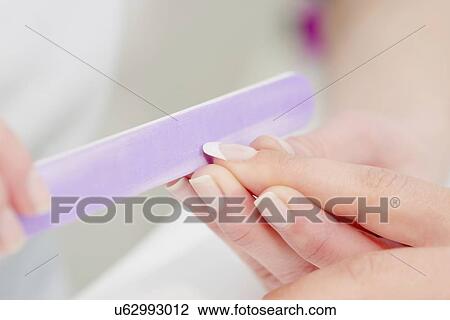 Stock Image - Woman having manicure. Fotosearch