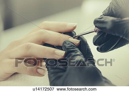 Woman having manicure View Large Photo Image Stock Photo - Woman having manicure. Fotosearch