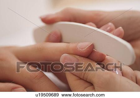 Woman having manicure View Large Photo Image Stock Photo - Woman having manicure. Fotosearch