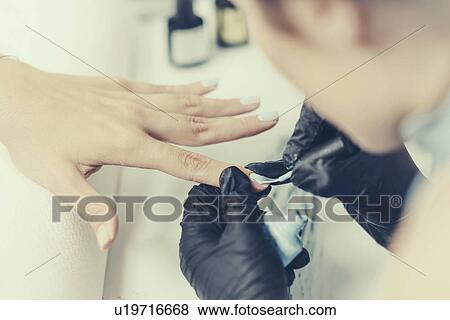 Woman having manicure View Large Photo Image Stock Photo - Woman having manicure. Fotosearch