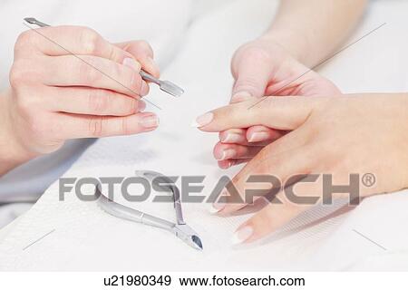 Woman having manicure View Large Photo Image Stock Photo - Woman having manicure. Fotosearch